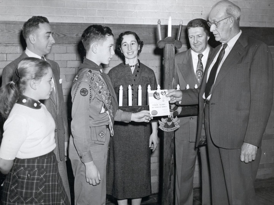 Young Michael Bloomberg receiving his Eagle Scout award in the company of his family